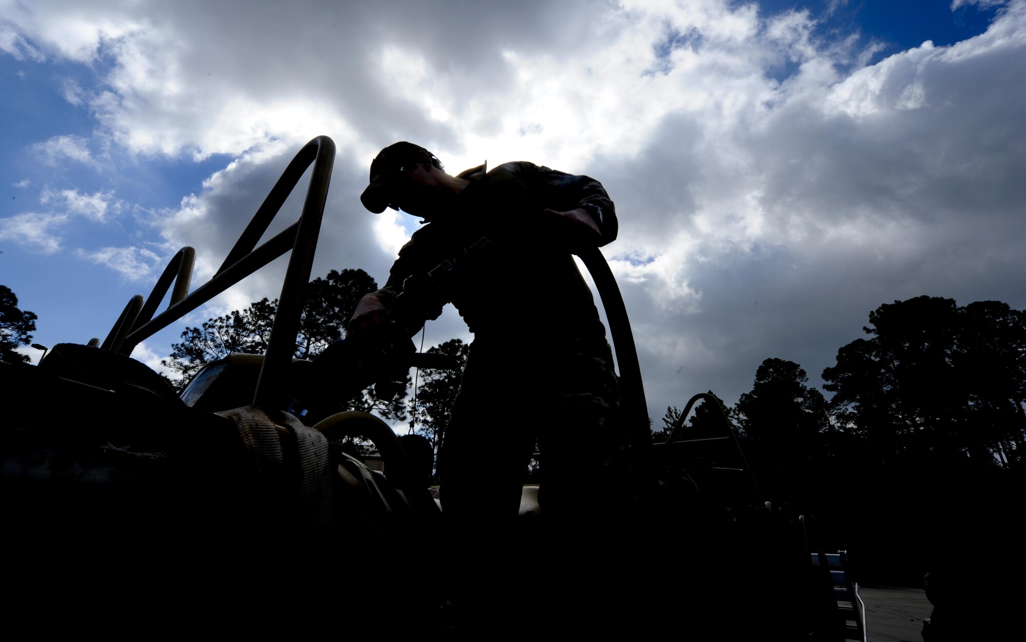 A Solider with 1st Battalion, 10th Special Forces Group, refuels the gas tank of an all-terrain vehicle at Buck Pond in Navarre, Fla., March 14, 2017. An instructor from the 1st Special Operations Support Squadron Operational Support Joint Office taught Soldiers riding techniques to qualify them for ATV usage in special operations missions. (U.S. Air Force photo by Airman 1st Class Dennis Spain)