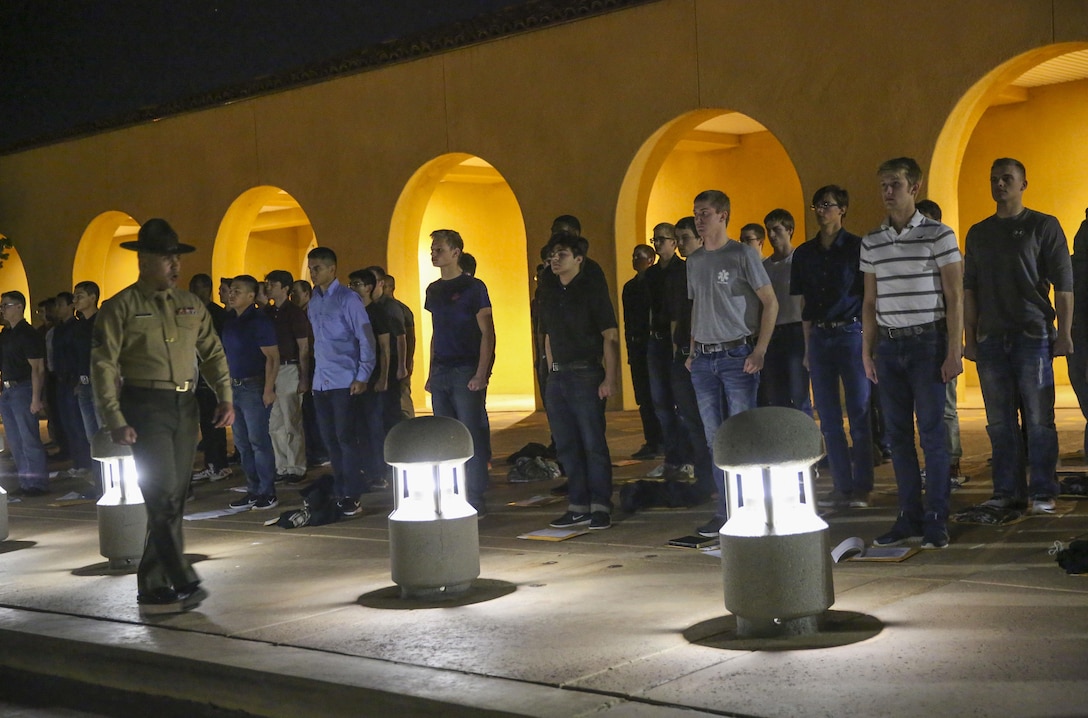 Recruits of Bravo Company, 1st Recruit Training Battalion, are welcomed to the depot by Staff Sgt. Christopher J. Burgess, chief drill instructor, Receiving Company, as they step onto the yellow footprints during receiving at Marine Corps Recruit Depot San Diego, March 6. From this point on, recruits will eat, sleep and train as a team as they begin the transformation from civilian to Marine. Annually, more than 17,000 males recruited from the Western Recruiting Region are trained at MCRD San Diego. Bravo Company is scheduled to graduate June 2.