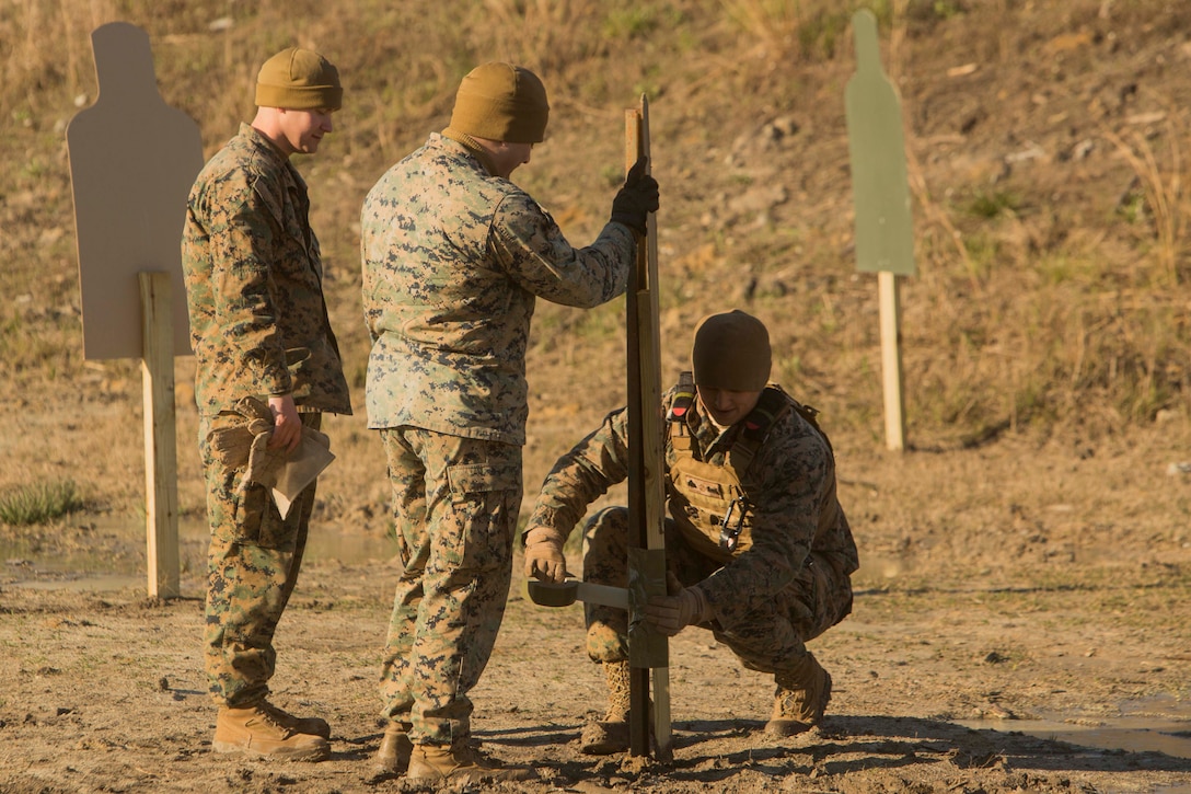 Marines prepare a target for demolition at Engineer Training Area 7 on Camp Lejeune, N.C., March 15, 2017. The Marines are undergoing basic demolitions training to increase proficiency and confidence with the employment of basic and expedient demolition charges. The Marines are with Combat Logistics Battalion 22, Headquarters Regiment. (U.S. Marine Corps photo by Pfc. Abrey Liggins)