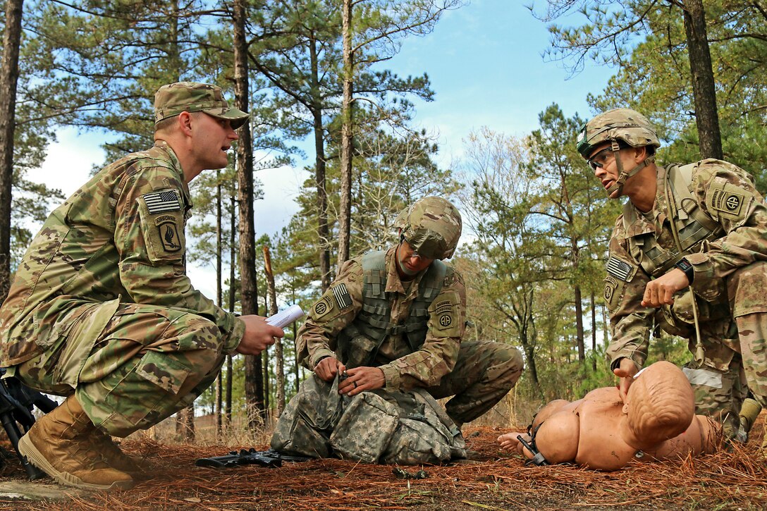 Army Sgt. Matthew Willich, left, evaluates soldiers conducting medical trauma training for upcoming Ranger, sapper and medic competitions at Fort Bragg, N.C., March 14, 2017. Army photo by Sgt. Paige Behringer