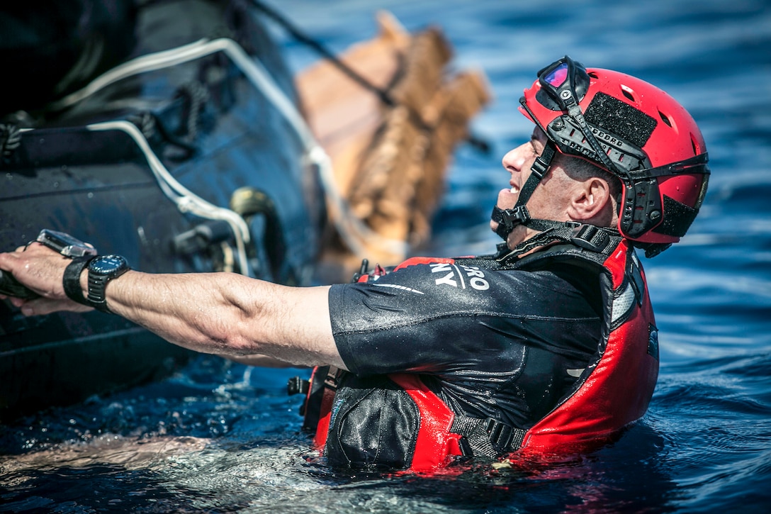 An Air National Guardsman prepares an inflatable boat for dispatch during training near Marine Corps Base Hawaii, March 6, 2017. The training prepared airmen to support and rescue NASA astronauts in the event of Orion spacecraft water landings. Marine Corps photo by Sgt. Brittney Vella