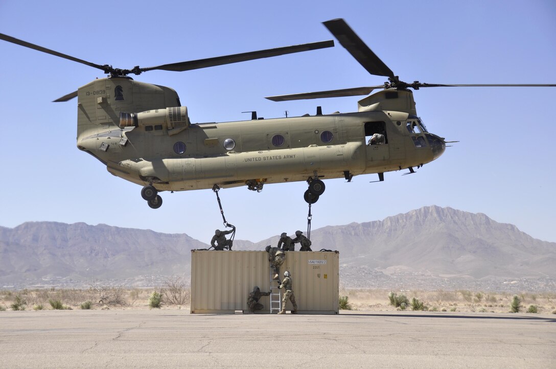 Soldiers attach a container to a CH-47 Chinook during slingload training at Biggs Army Airfield, Texas, March 10, 2017. The soldiers are assigned to the 1st Armored Division Sustainment Brigade. Army photo by Wendy Brown