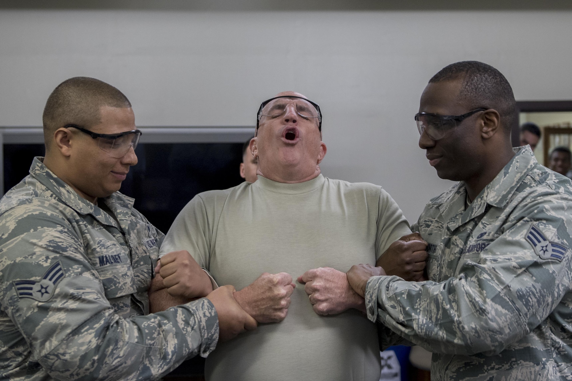 Col. Kenneth Moss, 374th Airlift Wing commander, reacts to getting tased during a 374th Security Forces Squadron less-lethal weapons demonstration March 15, 2017, at Yokota Air Base, Japan. Moss volunteered to be part of the demonstration to experience and understand more of what SFS members go through and to show his support. (U.S. Air Force photo by Airman 1st Class Donald Hudson)