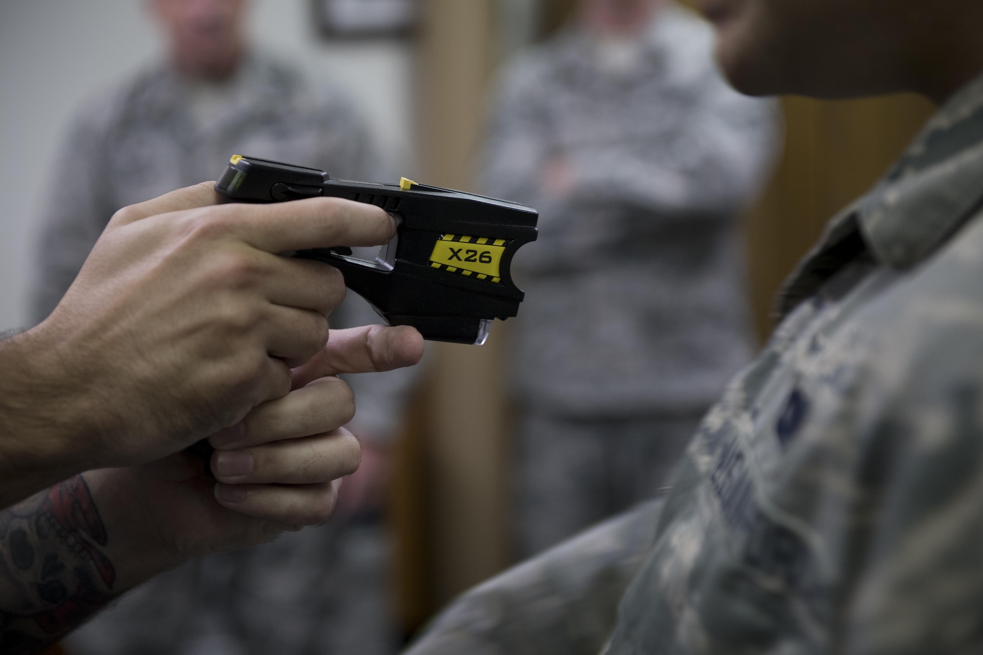 A 374th Security Forces Squadron member pulls away after experiencing a “drive tase,” during a nonlethal weapons demonstration March 15, 2017, at Yokota Air Base, Japan. A drive tase is when the taser is directly applied to the body of an individual. (U.S. Air Force photo by Airman 1st Class Donald Hudson)