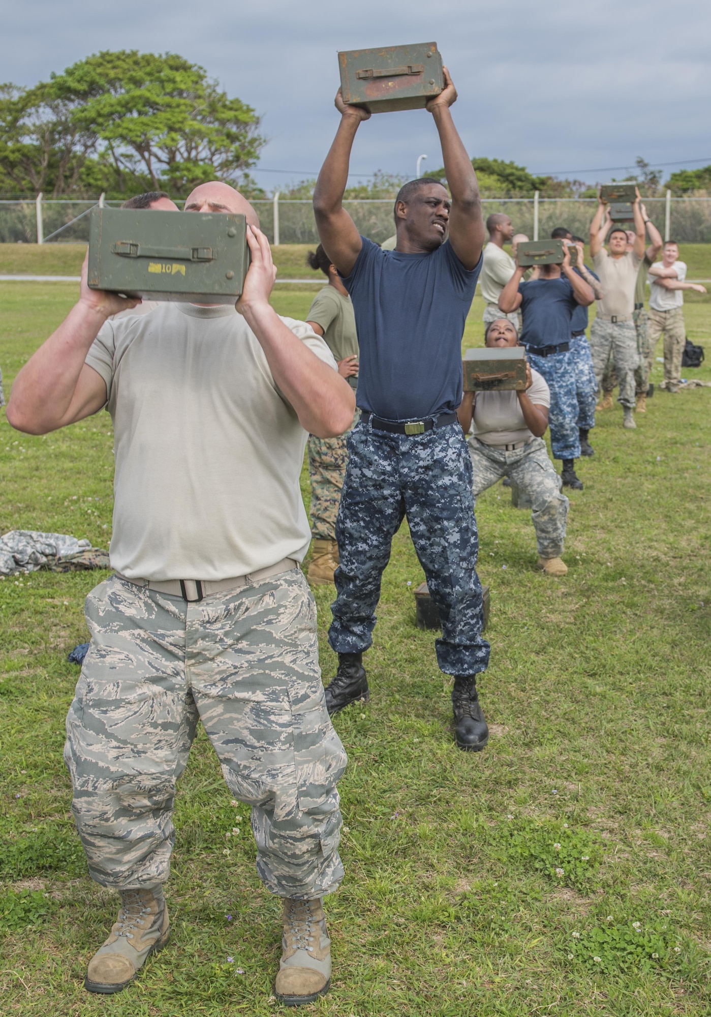 Service members participate in a portion of a U.S. Marine Corps fitness test March 16, 2017, at Camp Hansen, Japan. Enlisted members from across the sister services took part in three events designed to test the fitness of U.S. Marines. Throughout the week, the members participated in events and demonstrations designed to broaden their knowledge on what each branch does and brings to the fight.  (U.S. Air Force Photo by Senior Airman Nick Emerick)