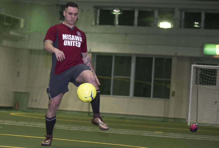 U.S. Air Force Staff Sgt. Jordan Churchill, a 35th Maintenance Group transient alert/crash recovery craftsman, kicks a soccer ball during a warmup prior to soccer practice, at Misawa, Japan, March 14, 2017. Churchill played soccer since he was five years old. The men and women of Misawa Air Base engage with the Japanese allies both on and off duty to build a deeper relationship and better understanding of the Japanese culture. (U.S. Air Force photo by Staff Sgt. Melanie Hutto)