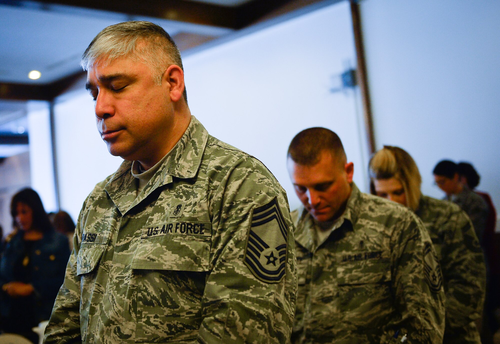 Military and civilian members bow their heads in prayer during a National Prayer Breakfast on Ramstein Air Base, Germany, March 13, 2017. The event saw attendance from all branches of the military, and from people of various religious backgrounds. The 86th Airlift Wing Chaplain Corps hosted the interdenominational event. (U.S. Air Force photo by Airman 1st Class Joshua Magbanua)