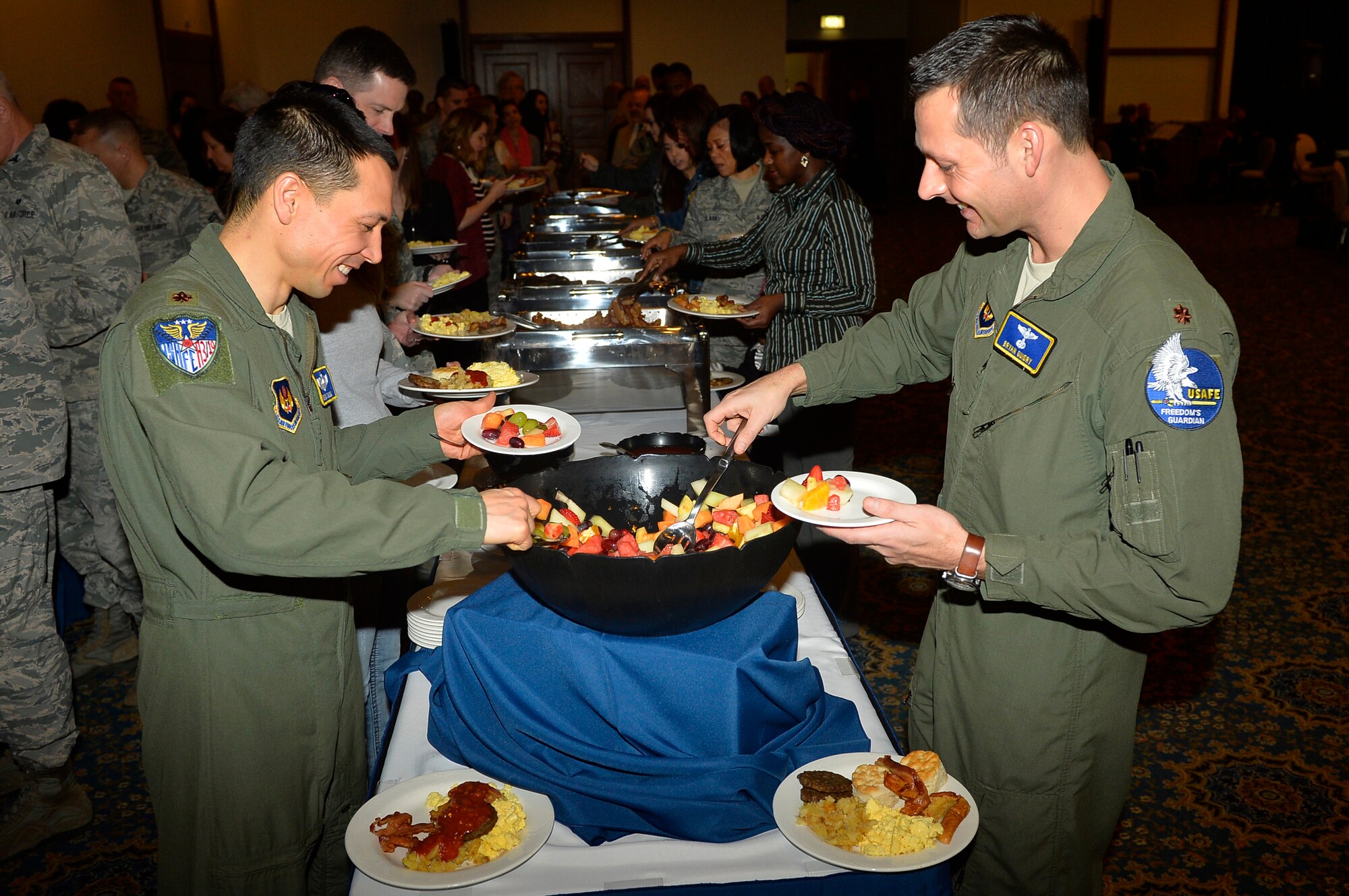 Military and civilian members of the Department of Defense prepare to eat breakfast during a National Prayer Breakfast on Ramstein Air Base, Germany, March 13, 2017. Members from three of the service branches of the military participated in the prayer breakfast. The 86th Airlift Wing Chaplain Corps hosted the event. (U.S. Air Force photo by Airman 1st Class Joshua Magbanua)