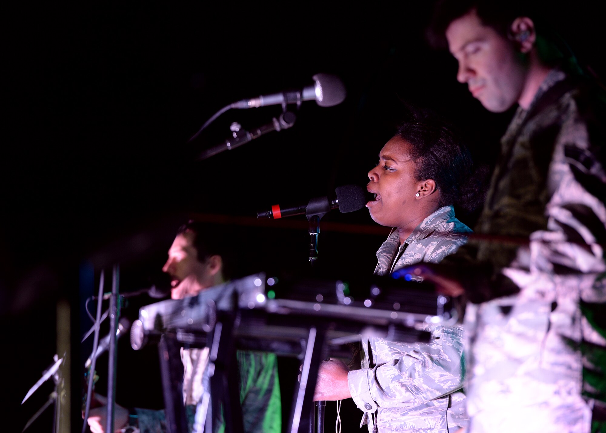 Senior Airman Paula Hunt, United Stated Air Forces in Europe Band vocalist, sings during a performance at Nigerien Air Base 201, Agadez, Niger, March 10, 2017. Hunt and her band-mates played the first concert for deployed Airmen at Nigerien AB 201. (U.S. Air Force photo by Senior Airman Jimmie D. Pike)