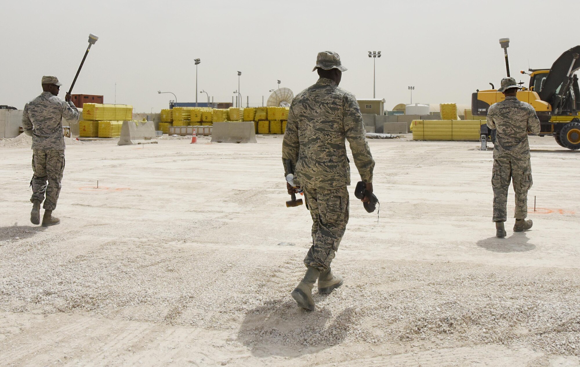 Airmen with the 379th Expeditionary Civil Engineer Squadron GEOBASE section prepare to survey a future construction site at Al Udeid Air Base, Qatar, March 15, 2017. These Airmen used a global positioning system hand-held unit to plot points for the structure that will be built. (U.S. Air Force photo by Senior Airman Cynthia A. Innocenti)