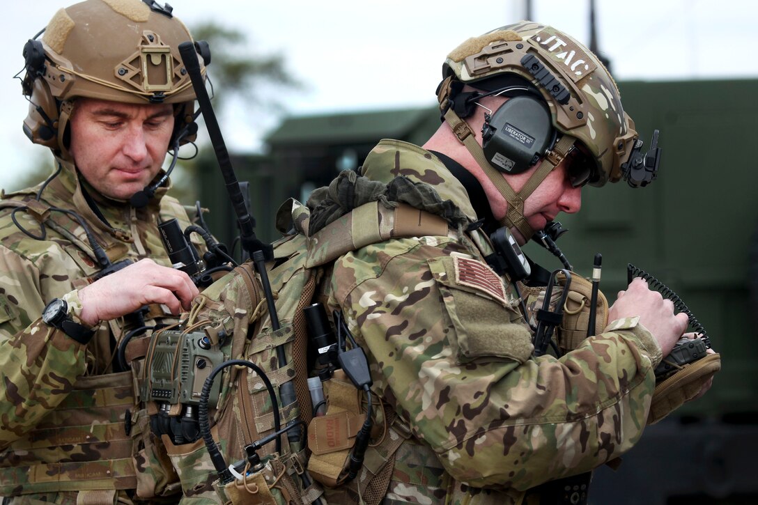 New Jersey Air National Guard Master Sgt. Chris Donohue, left, helps Senior Airman Ryan Muller with his tactical gear during an exercise at Warren Grove Gunnery Range, N.J., March 8, 2017. Donohue and Muller are tactical air control party airmen assigned to the 227th Air Support Operations Squadron. Air National Guard photo by Master Sgt. Matt Hecht