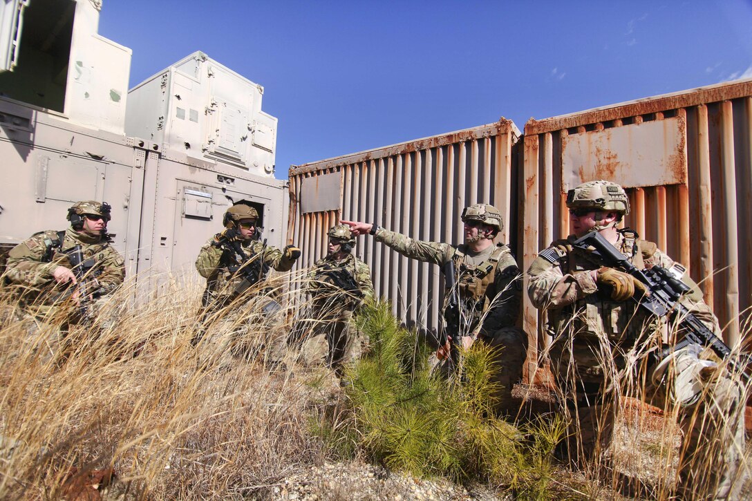 New Jersey Air National Guardsmen hold a security position before attempting to breach a door during an exercise at Warren Grove Gunnery Range, N.J., March 8, 2017. Air National Guard photo by Master Sgt. Matt Hecht