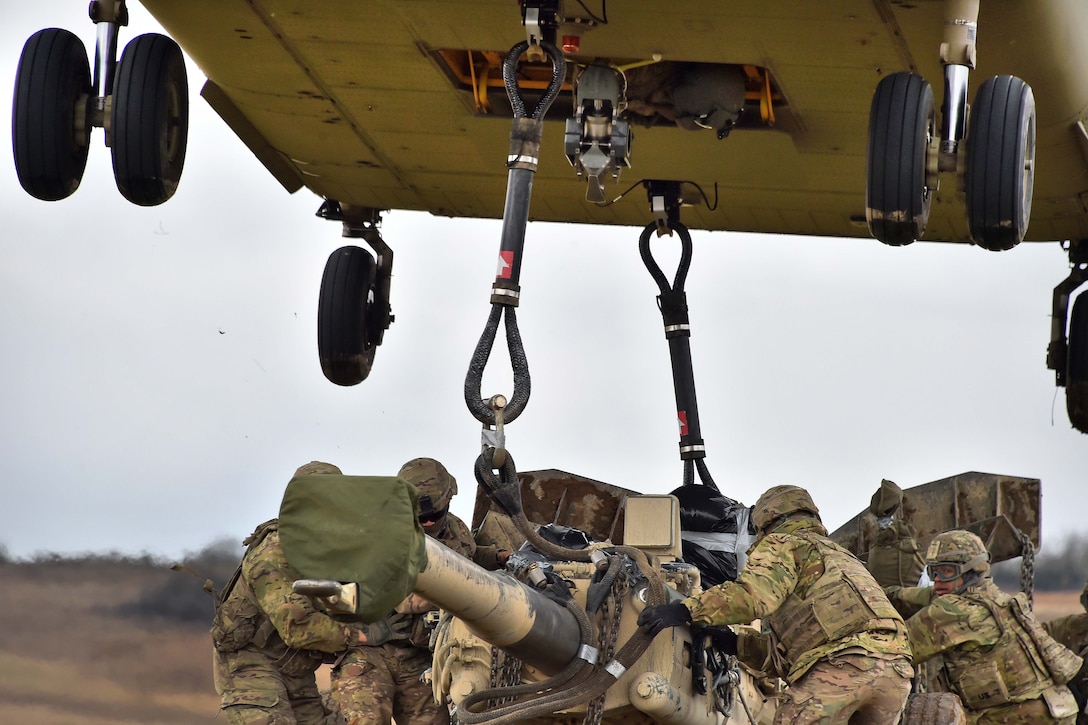 Soldiers unhook an M777 howitzer from a CH-47 Chinook helicopter during exercise Dynamic Front II at the 7th Army Training Command's Grafenwoehr Training Area, Germany, March 9, 2017. Army photo by Gertrud Zach