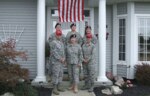 Members of the Clemens family, with more than 120 years of military service, stand in front of the family home in Port Clinton, Ohio, after three of them returned from overseas deployments. Pictured are retired Senior Master Sgt. Ken Clemens (clockwise from front row, left), Col. Barb Herrington-Clemens, Capt. Chelsea Migura, Staff Sgt. Rich Clemens, Staff Sgt. Drew Clemens and Sgt. 1st Class Zach Migura. 