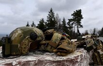 A helmet, vest, and gloves lay on a rock before the start of the U.S. Air Forces in Europe Air-Ground Operations School’s Joint Terminal Attack Controller Qualification Course at Grafenwoehr Training Area, Germany, March 15, 2017. Due to the aircraft dropping live ammunition, students and instructors for the course were required to wear protective gear. (U.S Air Force photo by Senior Airman Tryphena Mayhugh)