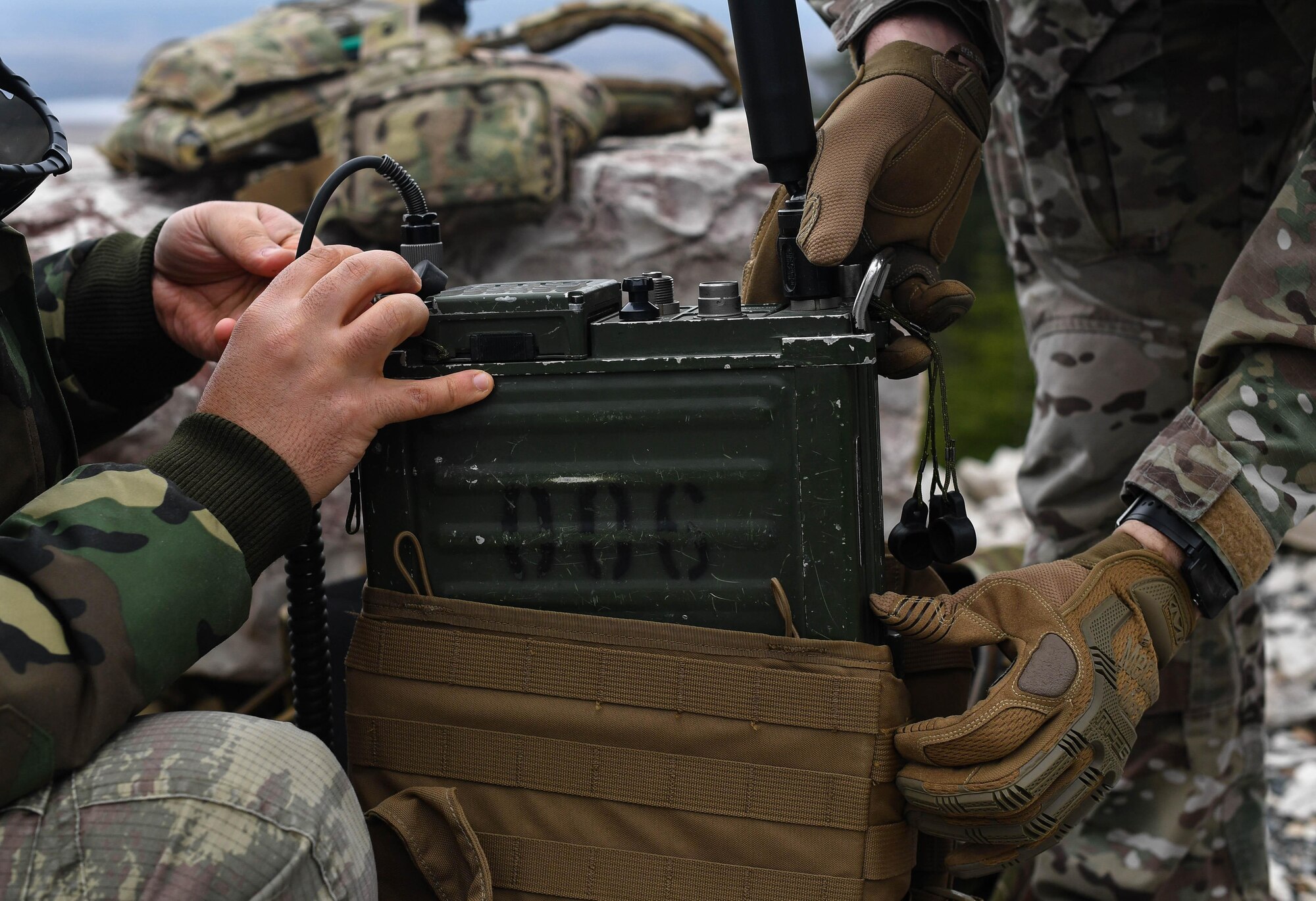 U.S. Air Force Senior Airman Jacob Hughes, right, 146th Air Support Operations Squadron tactical air control party, helps another student fit a radio into a backpack during the U.S. Air Forces in Europe Air-Ground Operations School’s Joint Terminal Attack Controller Qualification Course at Grafenwoehr Training Area, Germany, March 15, 2017. The class consisted of one American, one German, and two Turkish students. (U.S Air Force photo by Senior Airman Tryphena Mayhugh)