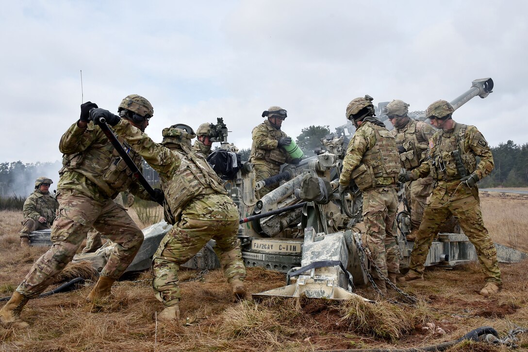 Soldiers load a round into an M777 howitzer during exercise Dynamic Front II at the 7th Army Training Command's Grafenwoehr Training Area, Germany, March 9, 2017. Army photo by Gertrud Zach