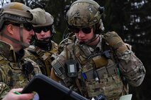 U.S. Air Force Master Sgt. Tom Moody, U.S. Air Forces in Europe Air-Ground Operations School squadron superintendent and joint terminal attack controller instructor, goes over information with U.S. Air Force Senior Airman Jacob Hughes, 146th Air Support Operations Squadron tactical air control party, during the USAFE AGOS’s JTAC Qualification Course at Grafenwoehr Training Area, Germany, March 15, 2017. The JTACQC is offered by the Warrior Preparation Center. (U.S Air Force photo by Senior Airman Tryphena Mayhugh)
