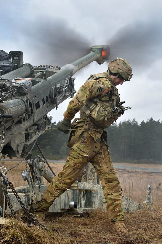 Army Spc. Vincent Ventarola pulls the lanyard on an M777 howitzer during exercise Dynamic Front II at the 7th Army Training Command's Grafenwoehr Training Area, Germany, March 9, 2017. Ventarola is assigned to the Field Artillery Squadron, 2nd Cavalry Regiment. Army photo by Gertrud Zach