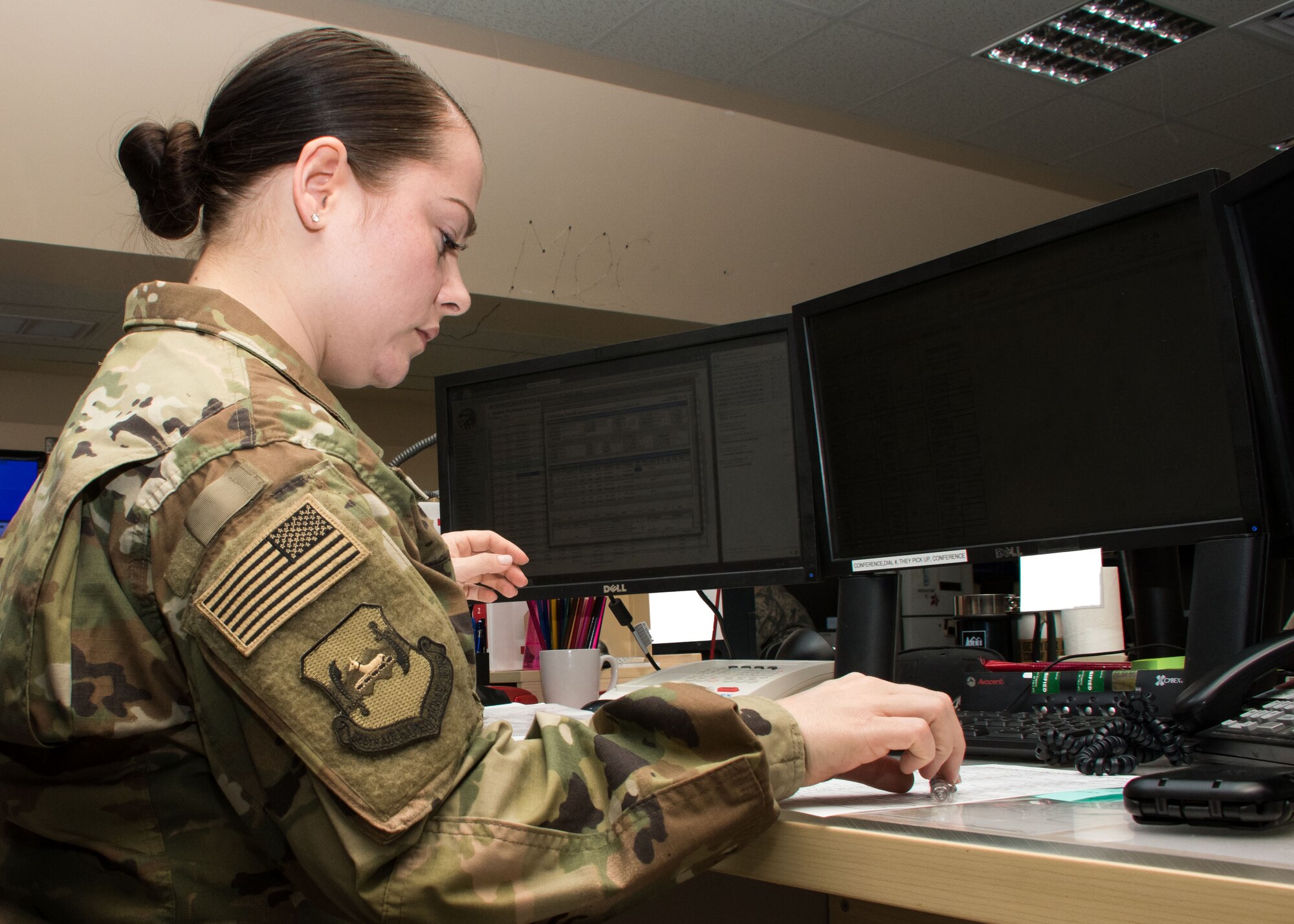 Senior Airman Laurin Curtis, a 386th AEW emergency action controller, works at a console in the command post March 15, 2017. “One thing I think that I’m really fortunate in is to be able to see the mission as a whole from a bird’s eye view...,” said Curtis. (U.S. Air Force photo illustration/Senior Airman Andrew Park)