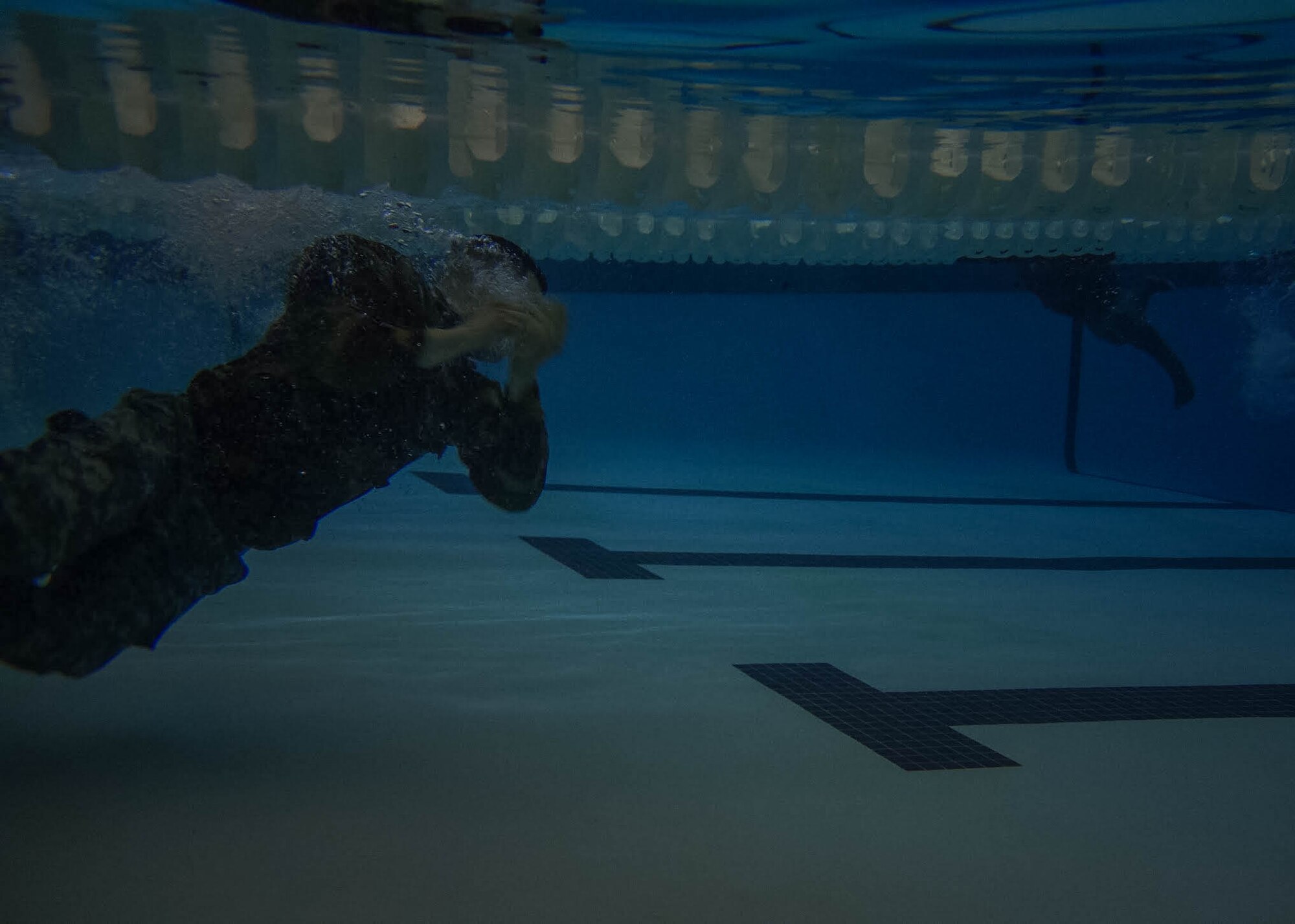 A U.S. Army Soldier struggles to remove his uniform during the underwater portion of the German Armed Forces Badge for military Proficiency (GAFBP) competition held at Fr. Drum, N.Y. on Saturday, march 11, 2017. The day began with 84 competitors and ended with 40 qualified finishers. The pool portion of the contest is where most participants were eliminated. (U.S. Air Force photo by Staff Sgt. Richard Mekkri)