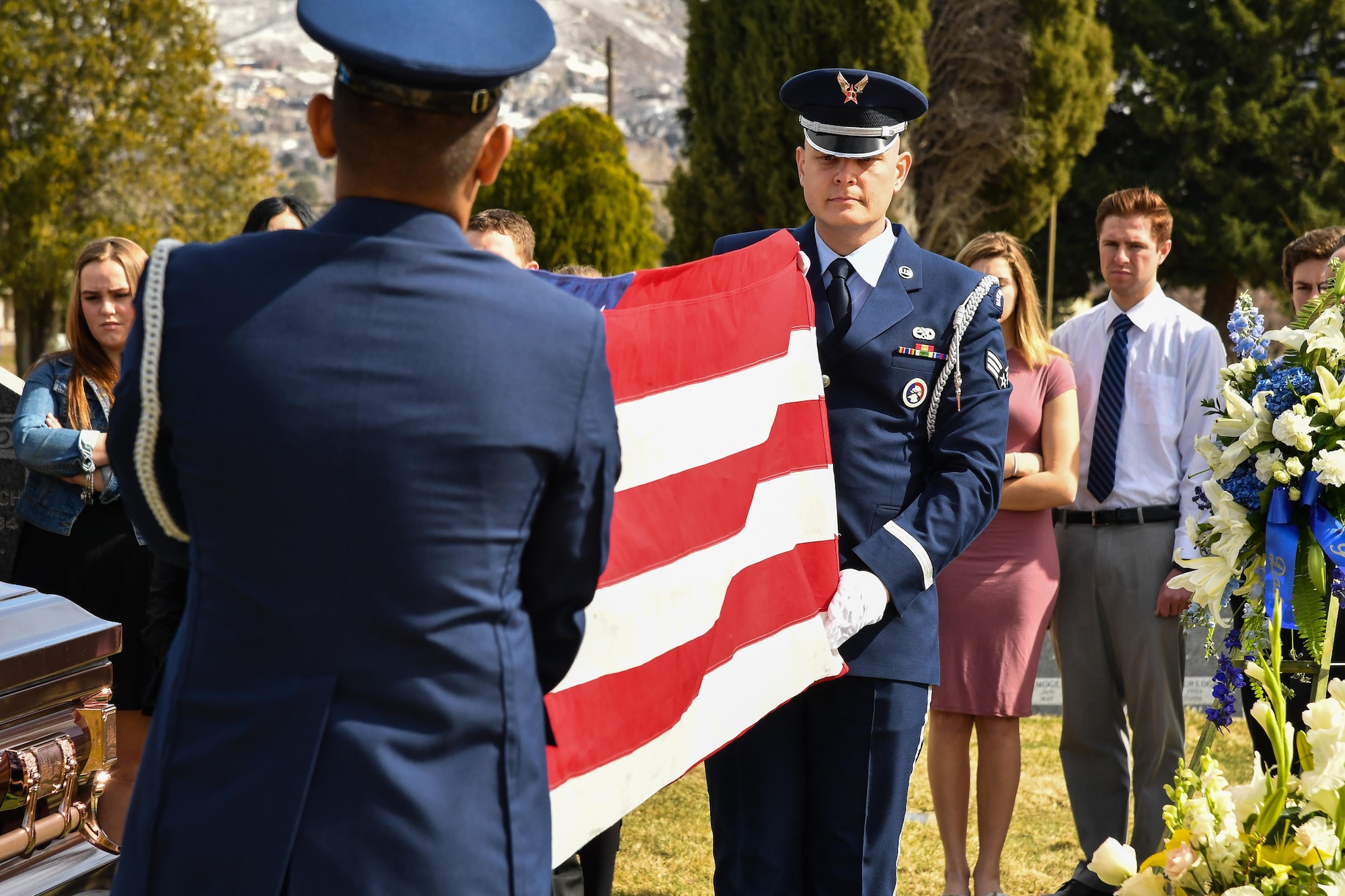 Hill AFB Honor Guard members Airman 1st Class Santos Vargas and Senior Airman James Fahrner perform a two-person flag fold during a veteran’s graveside service, Bountiful, Utah, March 8, 2017. Hill’s honor guard members provide professional military honors for a geographical area of 169,000 square miles (U.S. Air Force photo/R. Nial Bradshaw)