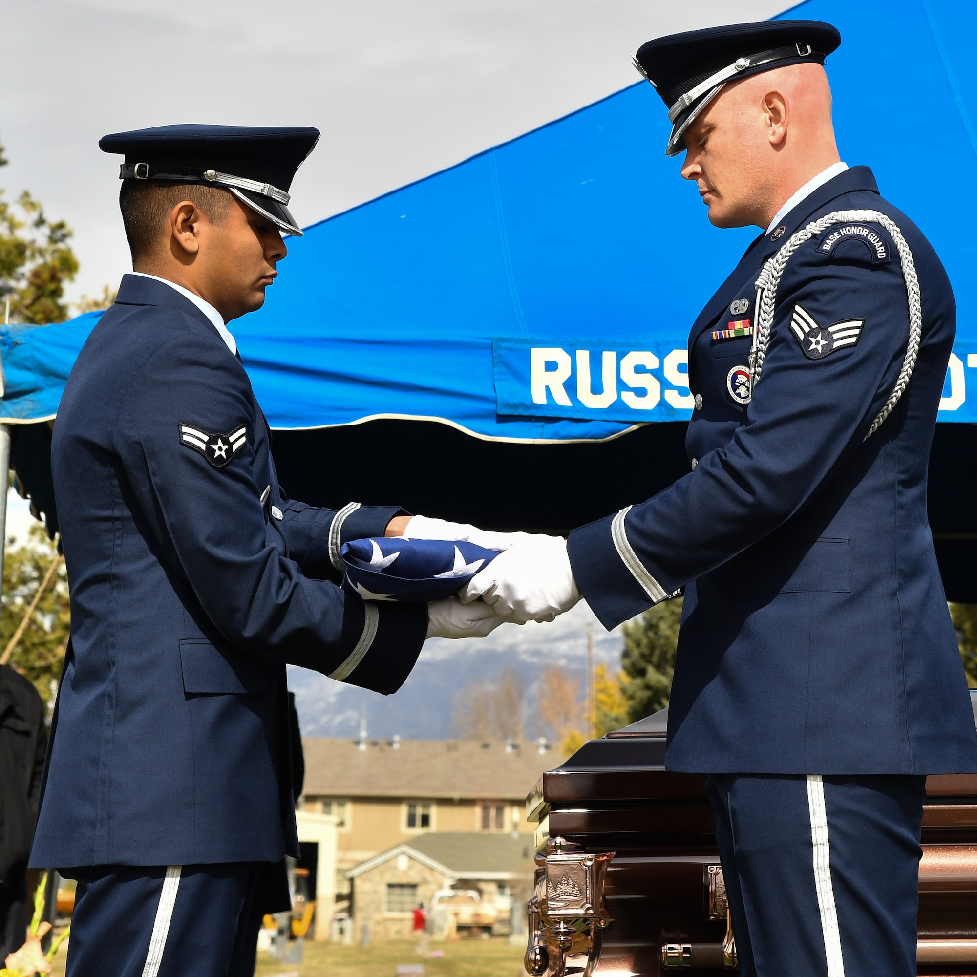 Hill AFB Honor Guard members Airman 1st Class Santos Vargas and Senior Airman James Fahrner complete a two-person flag fold during a veteran’s graveside service, Bountiful, Utah, March 8, 2017. Two-person flag folds are conducted during funerals, retirements and Retreat ceremonies. (U.S. Air Force photo/R. Nial Bradshaw)