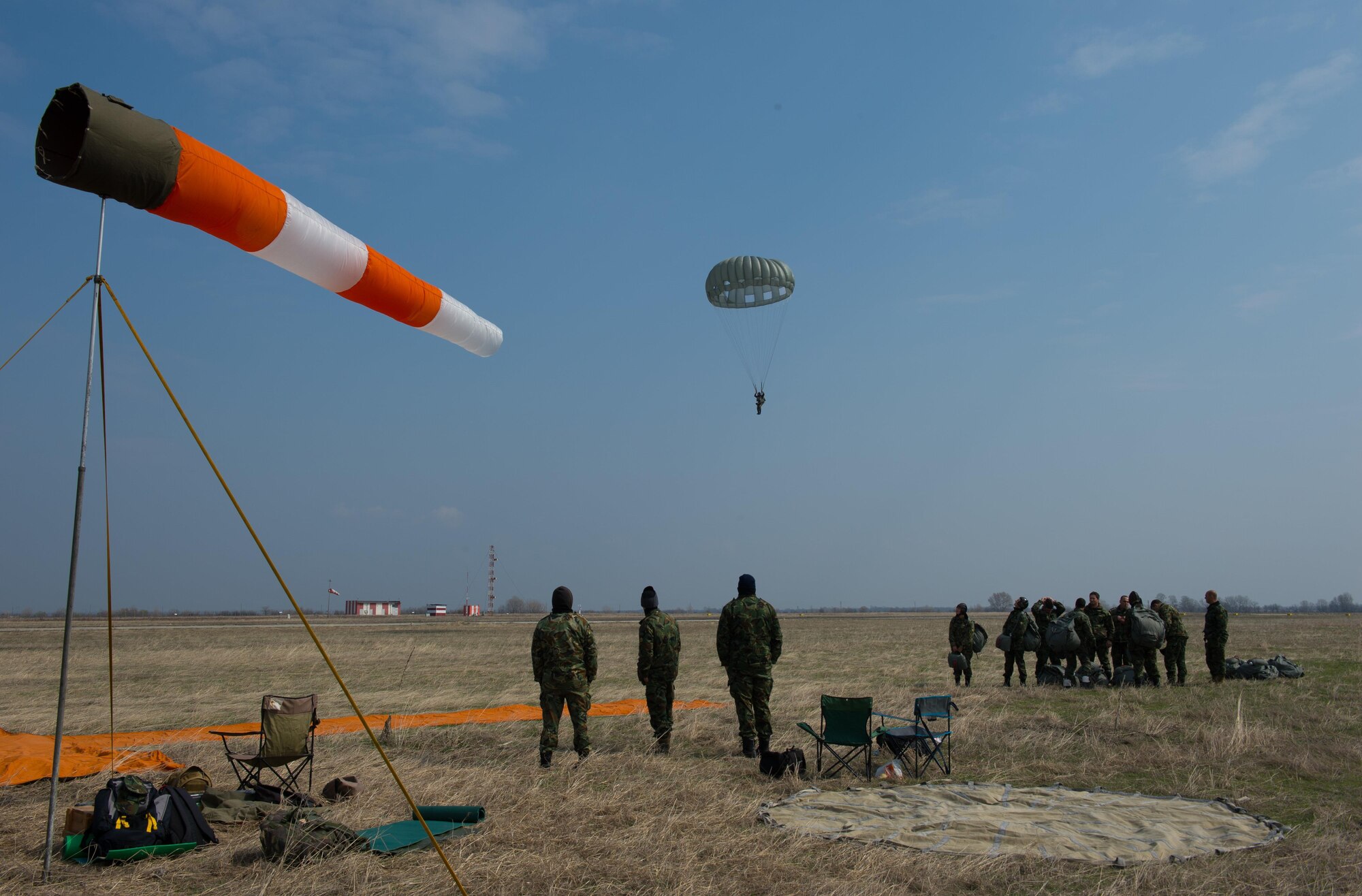 Bulgarian Special Operations drop zone personnel watch a Bulgarian service member descend during Exercise Thracian Spring 17 at Plovdiv Regional Airport, Bulgaria, March 15, 2017. Paratroopers exited the C-130J Super Hercules from approximately 1,250 feet before descending to the drop zone. More than 60 U.S. Air Force Airmen from Ramstein Air Base, Germany, participated in combined air operations with Bulgarian military to strengthen relationships while building their nations’ joint military capabilities. (U.S. Air Force photo by Staff Sgt. Nesha Humes)