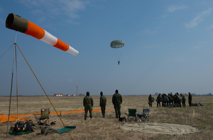 Bulgarian Special Operations drop zone personnel watch a Bulgarian service member descend during Exercise Thracian Spring 17 at Plovdiv Regional Airport, Bulgaria, March 15, 2017. Paratroopers exited the C-130J Super Hercules from approximately 1,250 feet before descending to the drop zone. More than 60 U.S. Air Force Airmen from Ramstein Air Base, Germany, participated in combined air operations with Bulgarian military to strengthen relationships while building their nations’ joint military capabilities. (U.S. Air Force photo by Staff Sgt. Nesha Humes)