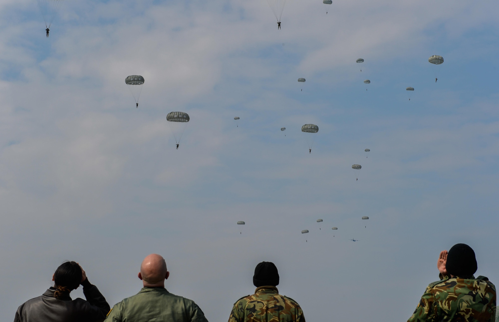 Exercise Thracian Spring 17 mission commanders and Bulgaria’s Special Operations help to count paratroopers as they parachute down to the drop zone at Plovdiv Regional Airport, Bulgaria, March 15, 2017. To prevent potential mishaps and injuries, aircraft loadmasters communicate with the drop zone safety officers to account for personnel exiting and landing on the ground. The U.S. Air Force’s forward presence in Europe allows Airmen to work hand-in-hand with Allies to develop and improve ready air forces that are capable of maintaining regional security.  (U.S. Air Force photo by Staff Sgt. Nesha Humes)