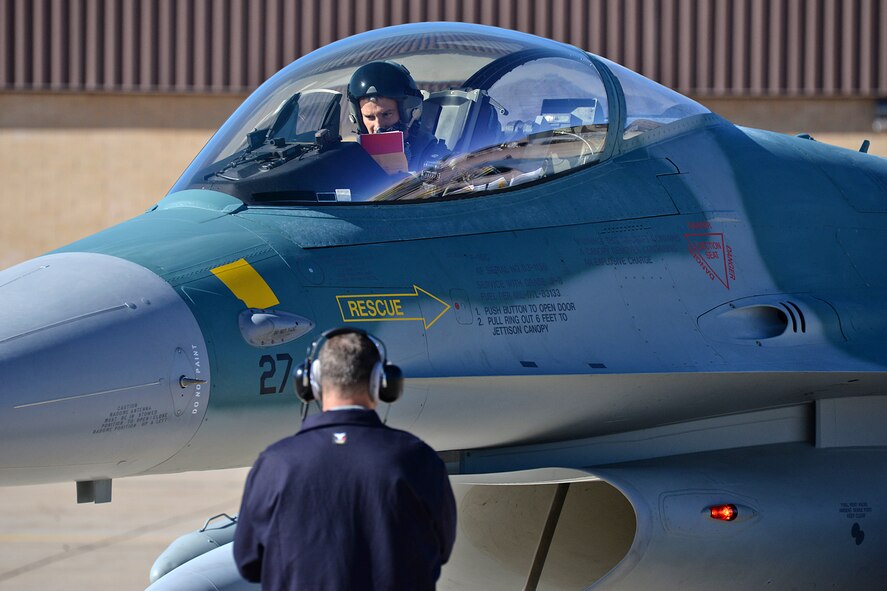 Ferry Cell 5 Flight Lead checks his flight documents prior to departure from Hill Air Force Base, Utah.  (U.S. Air Force Photo by Alex R. Lloyd)