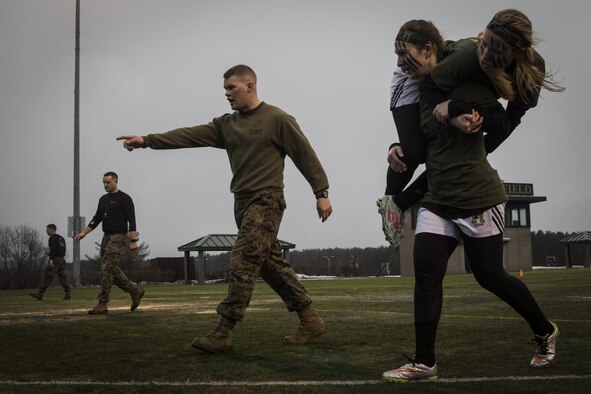 Isabell Smith, a freshman at Husson University and player with the Women Lacrosse Team, fireman-carries a teammate during the maneuver under fire portion of the Combat Fitness Test during a Leadership Seminar with Marine recruiters from Recruiting Substations Central and Northern Maine, March 8. The lacrosse team was run through the CFT, a series of circuit course exercises and activities, and a seminar on Marine Corps leadership traits and principles.