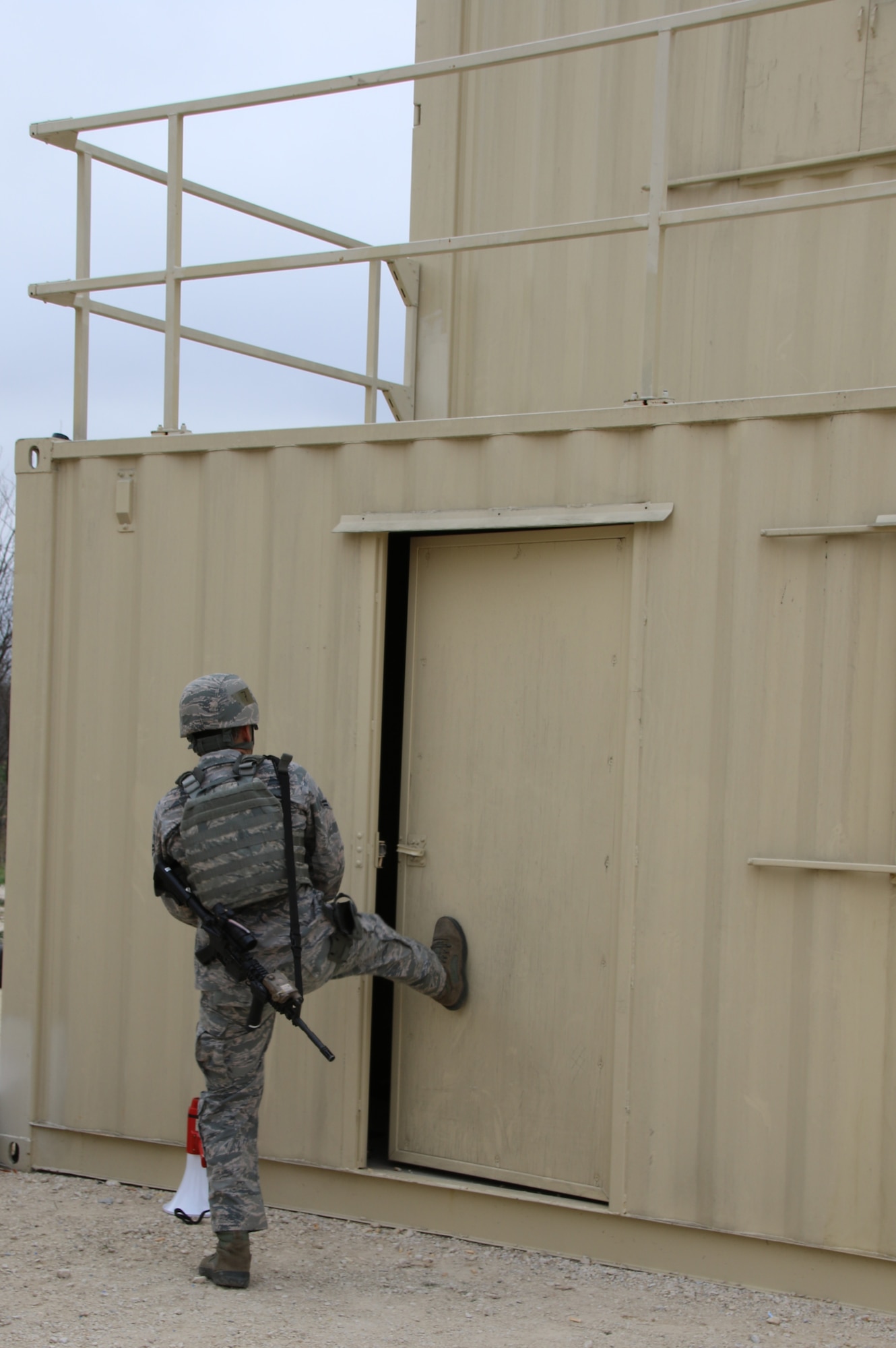 U.S. Air Force Airman 1st Class Johnny Guel, 7th Security Forces member, breaches a door during the room clearing portion of the Top Defender Challenge March, 11, 2017, at Dyess Air Force Base, Texas. During the room clearing portion of the challenge Airmen had to breach a building and perform shoot, don’t shoot scenarios as they maneuvered throughout the building. (U.S. Air Force Photo by Tricia Bruton)