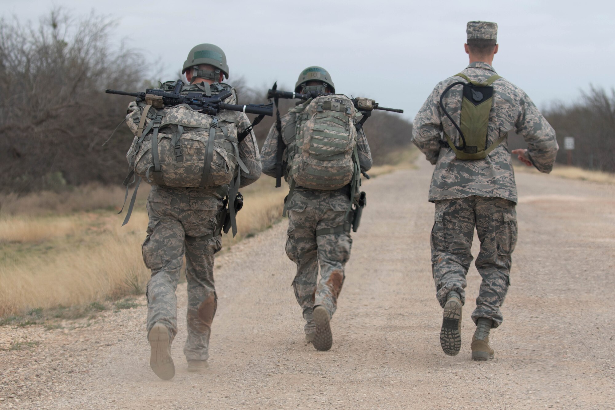 U.S. Air Force Airmen assigned to the 7th Security Forces Squadron march back to the squadron after completing the Top Defender Challenge March, 11, 2017, at Dyess Air Force Base, Texas. The event was designed to determine the best two-man team leading up to Air Force Global Strike Challenge. (U.S. Air Force Photo by Tricia Bruton)