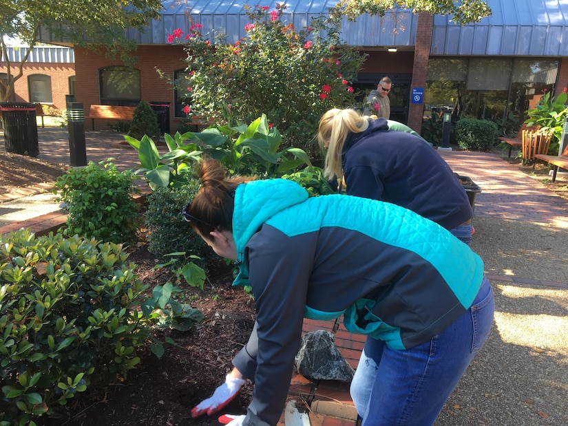 Members assigned to Joint Base Langley-Eustis, Va., spread mulch in horticultural therapy gardens at the Hampton Veteran Affairs Medical Center in Hampton, Va, Oct. 22, 2016.Gardens with plants that have colors, textures and fragrances that elicit a healing response are referred to as therapeutic gardens. (Courtesy photo)