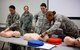 Airmen of the 932nd Airlift Wing helped each other adjust techniques during a Unit Training Assembly, as they refreshed CPR skills.  The letters CPR stand for Cardiopulmonary Resuscitation, and when a person stops breathing, or perhaps their heart stops beating effectively, this lifesaving technique is used to restore oxygenated blood flow to the vital organs quickly.  Basic life saving skills (BLS) were taught methodically, step by step, with 932nd AW instructors watching during Emergency Medical Technician training, inside the 932nd Medical Group. This included proper procedures for patient assessment and trauma treatment in a special class held recently at Scott Air Force Base, Ill. The 932nd Medical Group is one of four groups under the 932nd Airlift Wing, a 22nd Air Force unit in Illinois, and part of the Air Force Reserve Command.  (U.S. Air Force photo by Lt. Col. Stan Paregien)