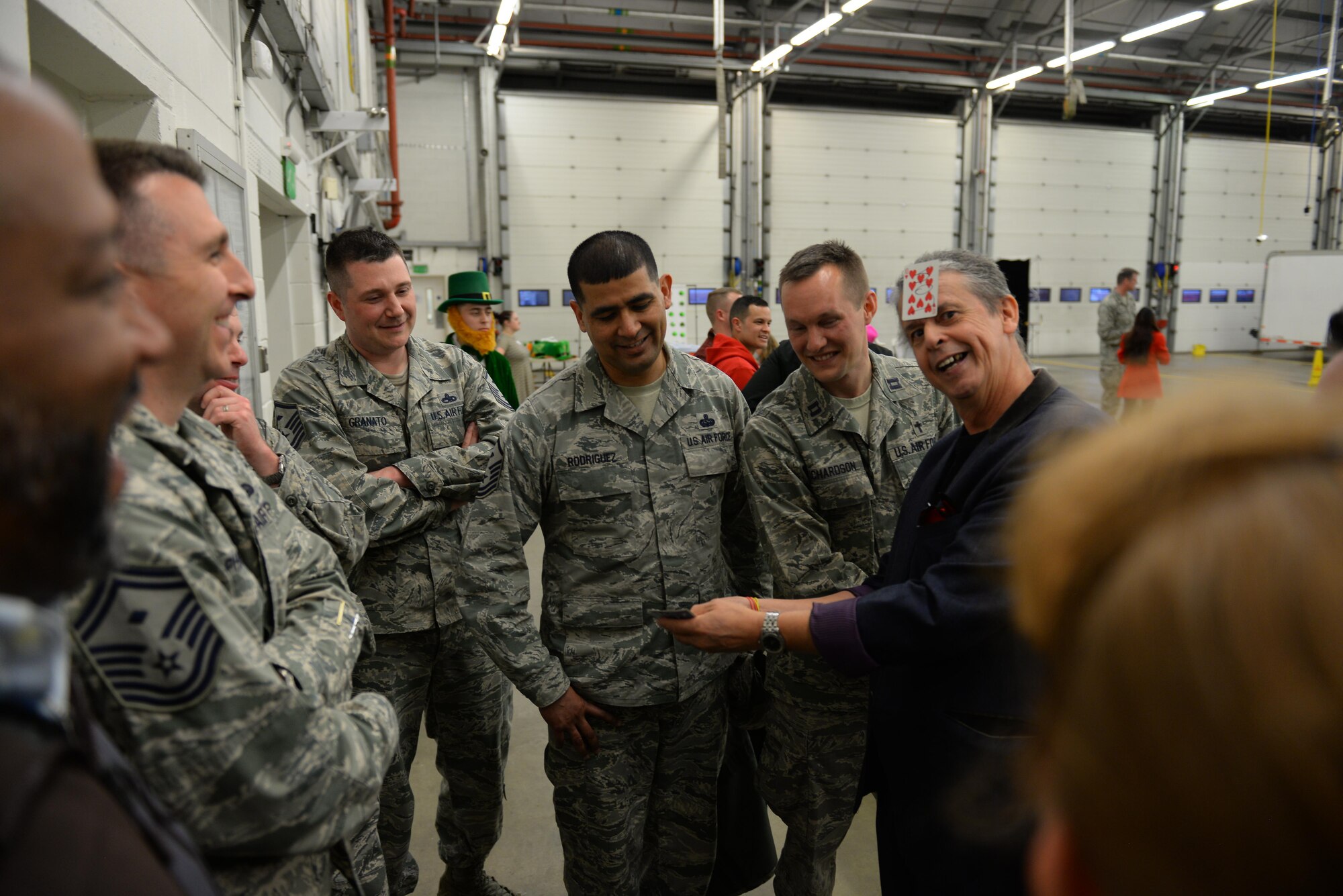 U.S. Air Force Airmen watch as magician Eric “El Rico” Armstrong, right, during Hearts Apart March 16, 2017, at the fire department on RAF Mildenhall, England. This month’s Hearts Apart event was hosted by the 100th Aircraft Maintenance Squadron. (U.S. Air Force photo by Staff Sgt. Micaiah Anthony)
