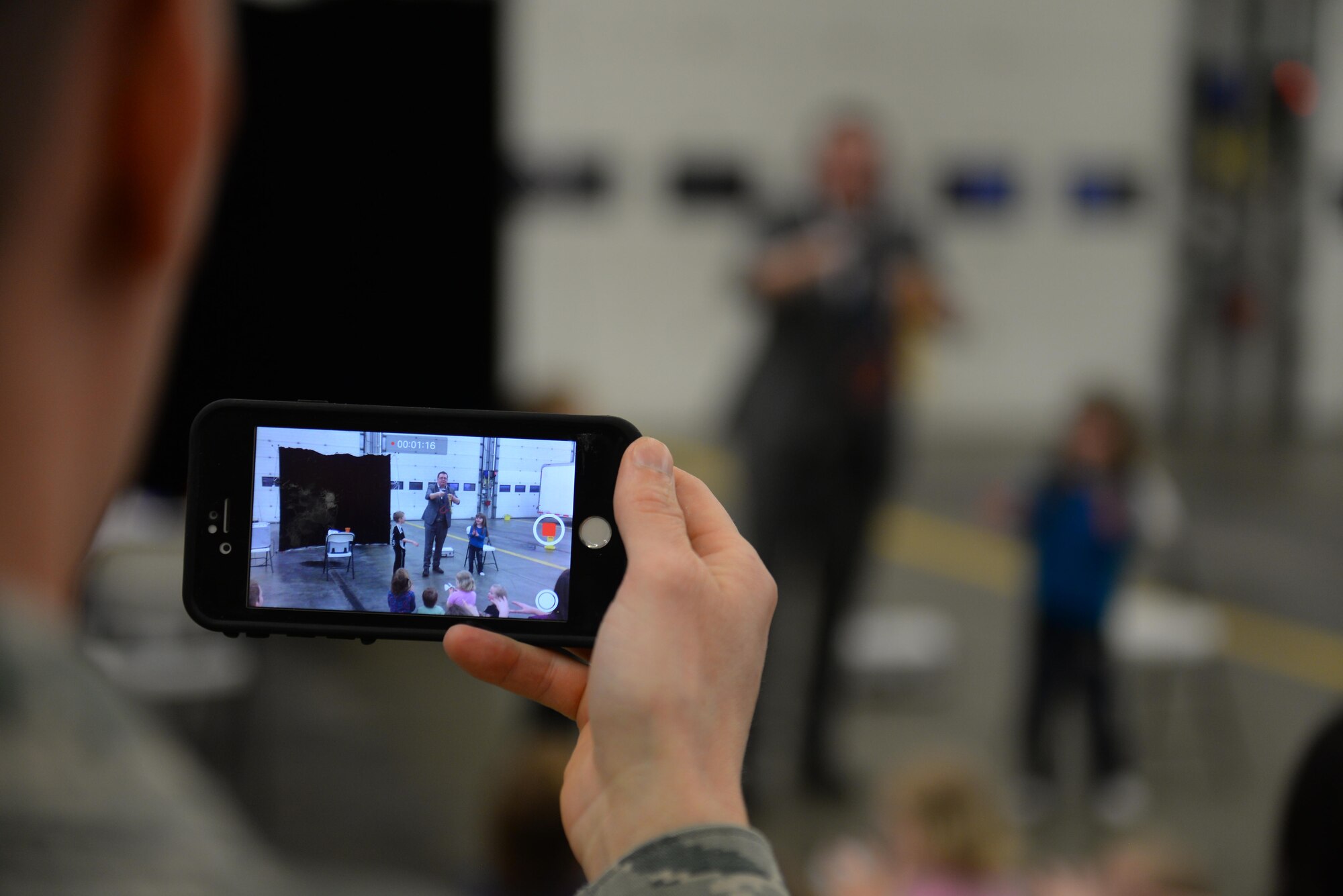 A U.S. Air Force Chaplain from the 352nd Special Operations Wing records a video of the children’s magic show during Hearts Apart March 16, 2017, at the fire department on RAF Mildenhall, England. This month’s Hearts Apart event was hosted by the 100th Aircraft Maintenance Squadron. (U.S. Air Force photo by Staff Sgt. Micaiah Anthony)