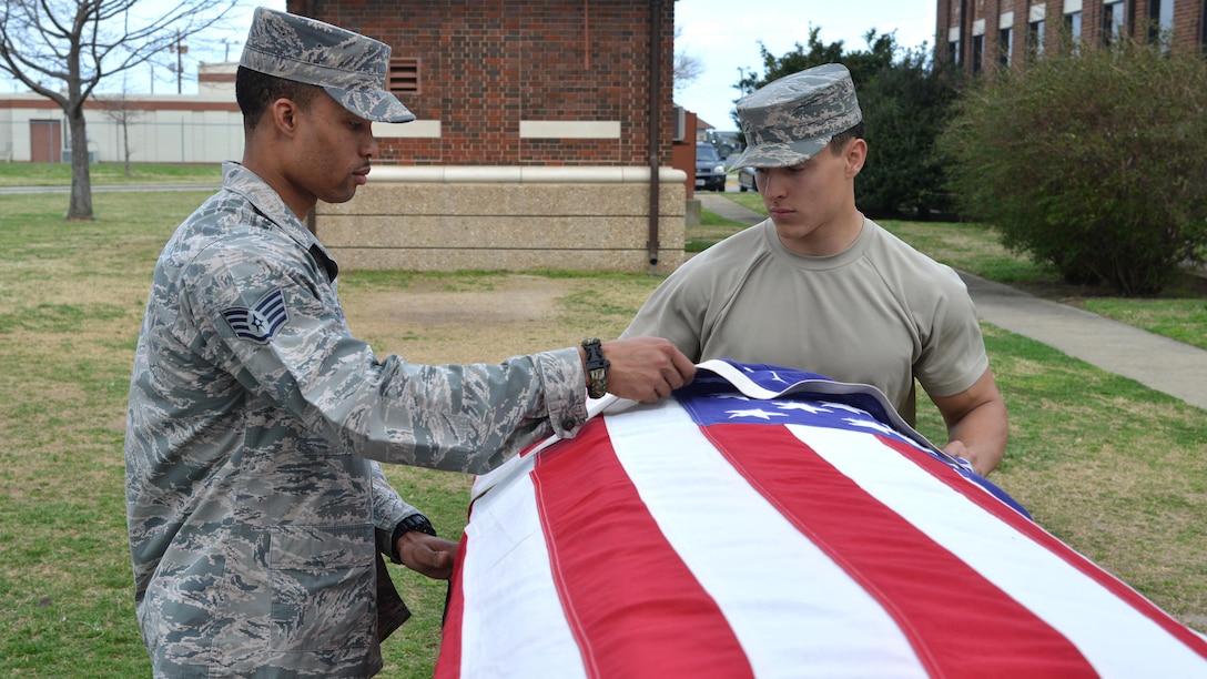 Air Force Staff Sgt. Quinton Gittens assists Airman 1st Class Noah Lalonde during honor guard training at Joint Base Langley-Eustis, Va., March 1, 2017. Gittens has dedicated seven years to the Langley Honor Guard. Air Force photo by Airman 1st Class Tristan Biese