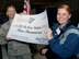 Col. John Price, commander, commandant of cadets (left) and Cadet 1st Class Madison Martin, hold up a 