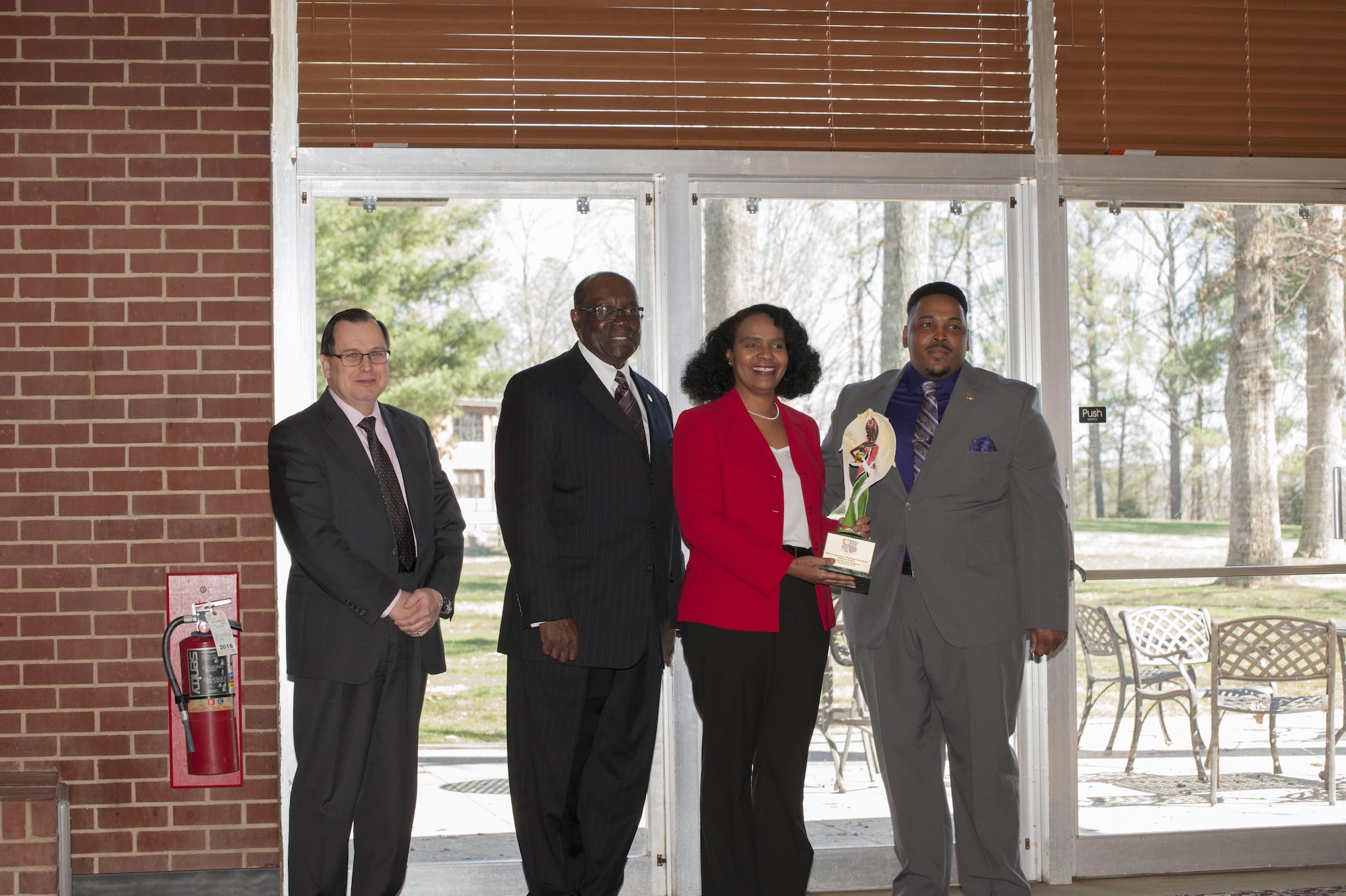 Willie Jo Taylor, second from right, a retiree of AEDC, received the AEDC African American Heritage Committee Achievement of Excellence award at the luncheon Feb. 16 at Arnold Lakeside Center. Taylor was one of the first black females to work at AEDC as part of a stay-in-school program in 1979. She was accompanied at the luncheon by her husband of 37 years, Gregory Taylor, and her daughter, AEDC team member Dana Taylor Henry. Pictured during the award presentation, left to right, are Dr. Mark Mehalic, AEDC executive director; Dr. Andrew Hugine Jr., president of Alabama A&M University; Taylor; and Artious Walker, member of the AEDC African American Heritage Committee. (U.S. Air Force photo/Jacqueline Cowan)
