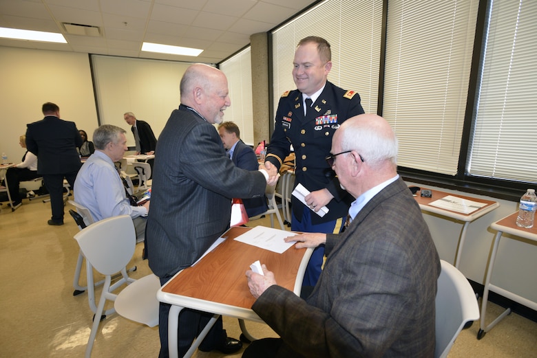 Maj. Christopher Burkhart, U.S. Army Corps of Engineers Nashville District deputy commander, welcomes Allen Scott of Wisdom Tree Technologies during the speed dating portion of the 6th Annual Small Business Industry Day at the Tennessee Small Business Development Center at Tennessee State University in Nashville, Tenn., March 15, 2017. The major and Roy Rossignol (seated), Nashville District Small Business chief, met with small business leaders during this matchmaking engagement. 