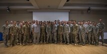 Airmen from the 38th Rescue Squadron pose for a photo with Retired Tech. Sgt. Keary Miller after a presentation, March 3, 2017, at Moody Air Force Base, Ga. Miller shared his story of the Battle of Roberts Ridge during the presentation. His goal was for the 38th RQS Pararescuemen to understand that what they do during their training has an impact down the road and they need to perform at a standard in order to be successful overseas. (U.S. Air Force photo by Airman 1st Class Lauren M. Sprunk)