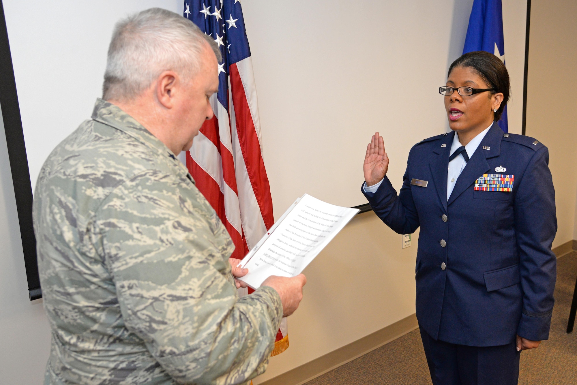 A picture of New Jersey National Guard Adjutant General Brig. Gen. Michael Cunniff swearing in U.S. Air Force 1st Lt. Anita Morris, a chaplain with the  New Jersey Air National Guard's 177th Fighter Wing, at her swearing-in ceremony, Feb. 12, 2017, at the 177th Fighter Wing.