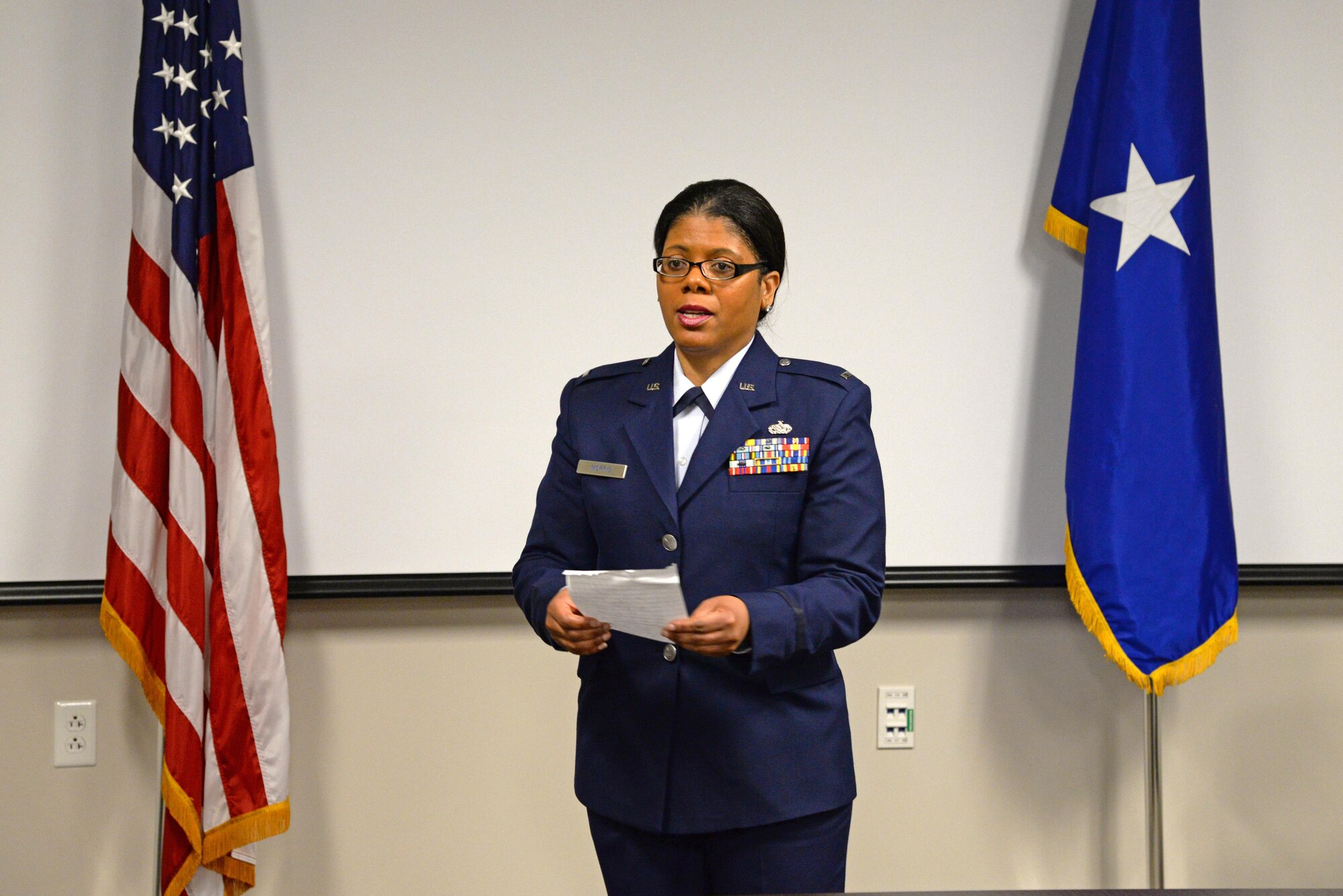A picture of U.S. Air Force 1st Lt. Anita Morris, a chaplain with the New Jersey Air National Guard's 177th Fighter Wing, speaking to a group of senior leaders, friends and family.
