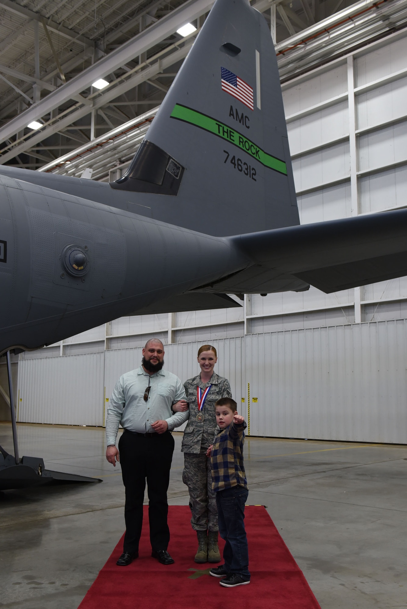 U.S. Air Force Senior Airman Katie Cogbill, 19th Medical Operations Squadron medical technician, poses for a photo with her husband, Daniel, and her son, Barrett, during the 2016 19th Airlift Wing Annual Awards ceremony Jan. 27, 2017, at Little Rock Air Force Base, Ark. Cogbill went up against four other Airmen from the 19th AW to win the award. (U.S. Air Force photo by Airman 1st Class Kevin Sommer Giron)