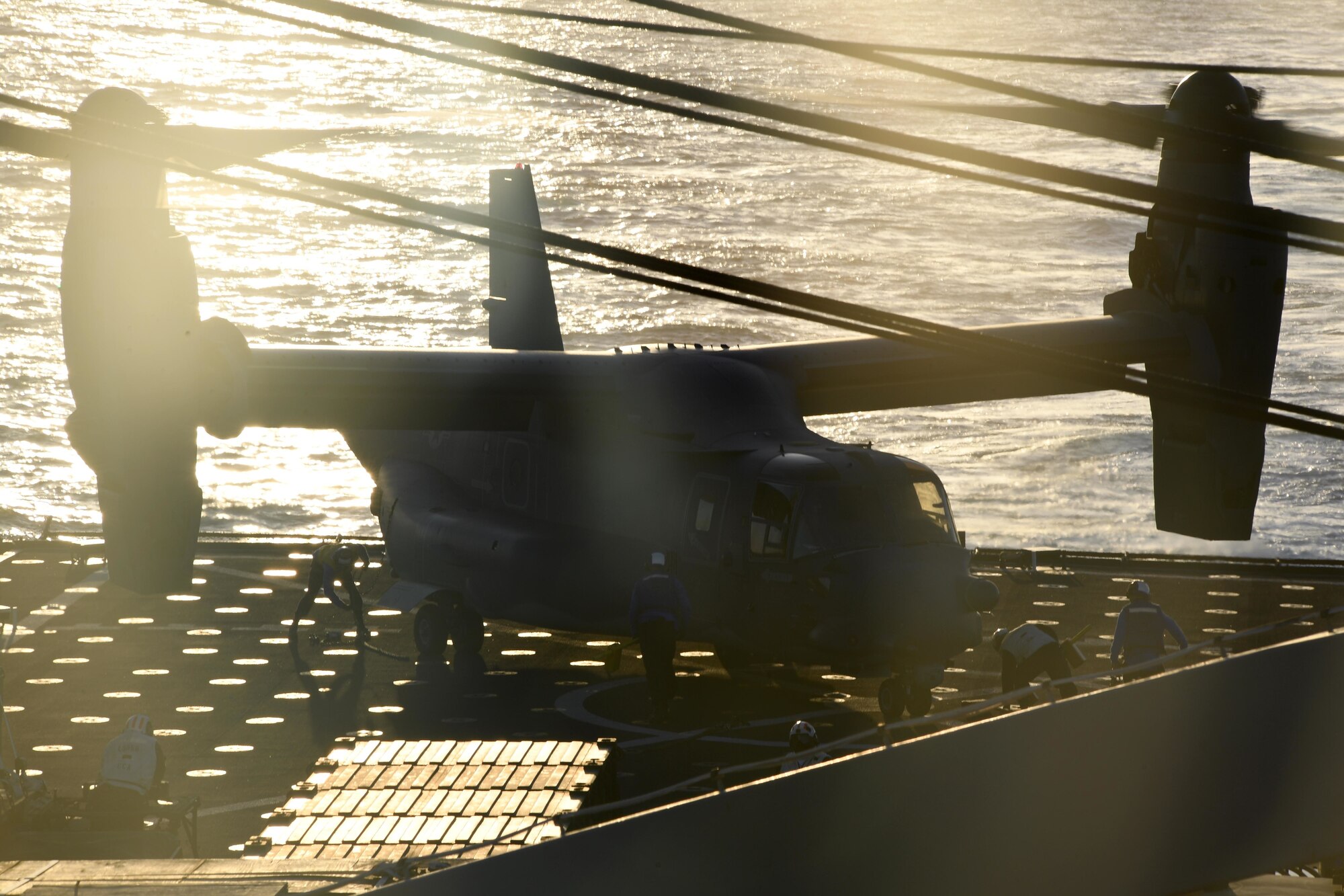 170312-N-ME988-800 MEDITERRANEAN SEA (March 12, 2017) Sailors aboard the amphibious dock landing ship USS Carter Hall (LSD 50) remove chocks and chains from a CV-22 Osprey assigned to Special Operations Command Europe during deck landing qualifications, March 12, 2017. The ship is deployed with the Bataan Amphibious Ready Group to support maritime security operations and theater security cooperation efforts in the U.S. 6th Fleet area of operations. (U.S. Navy photo by Mass Communication Specialist 1st Class Darren M. Moore/Released)