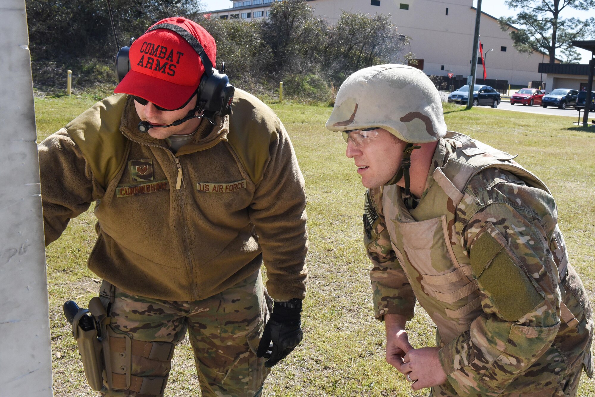 SSgt Cory Cunningham, a Combat Arms Training and Maintenance instructor with the 1st Special Operations Security Forces Squadron, evaluates Master Sgt. Derek Zarnesky’s target during a weapons qualification course at Hurlburt Field, Fla., March 16, 2017. Combat Arms Training and Maintenance instructors train and qualify Airmen on required weapons for deployments. (U.S. Air Force photo by Senior Airman Jeff Parkinson)