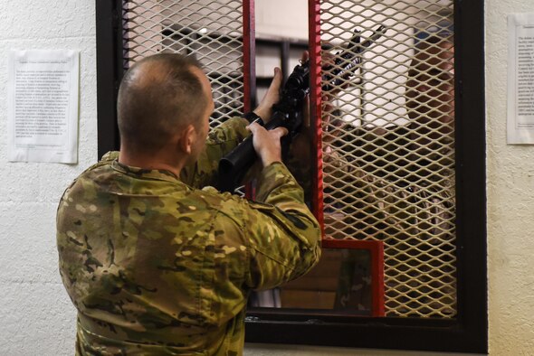 Master Sgt. Derek Zarnesky, flight chief with the 11th Special Operations Intelligence Squadron, is issued a M4 rifle during a weapons qualification course at the Combat Arms Training and Maintenance range, Hurlburt Field, Fla., March 16, 2017.  Air Commandos are required to qualify on the M9 pistol and M4 rifle prior to deploying to certain locations around the world.  (U.S. Air Force photo by Senior Airman Jeff Parkinson)