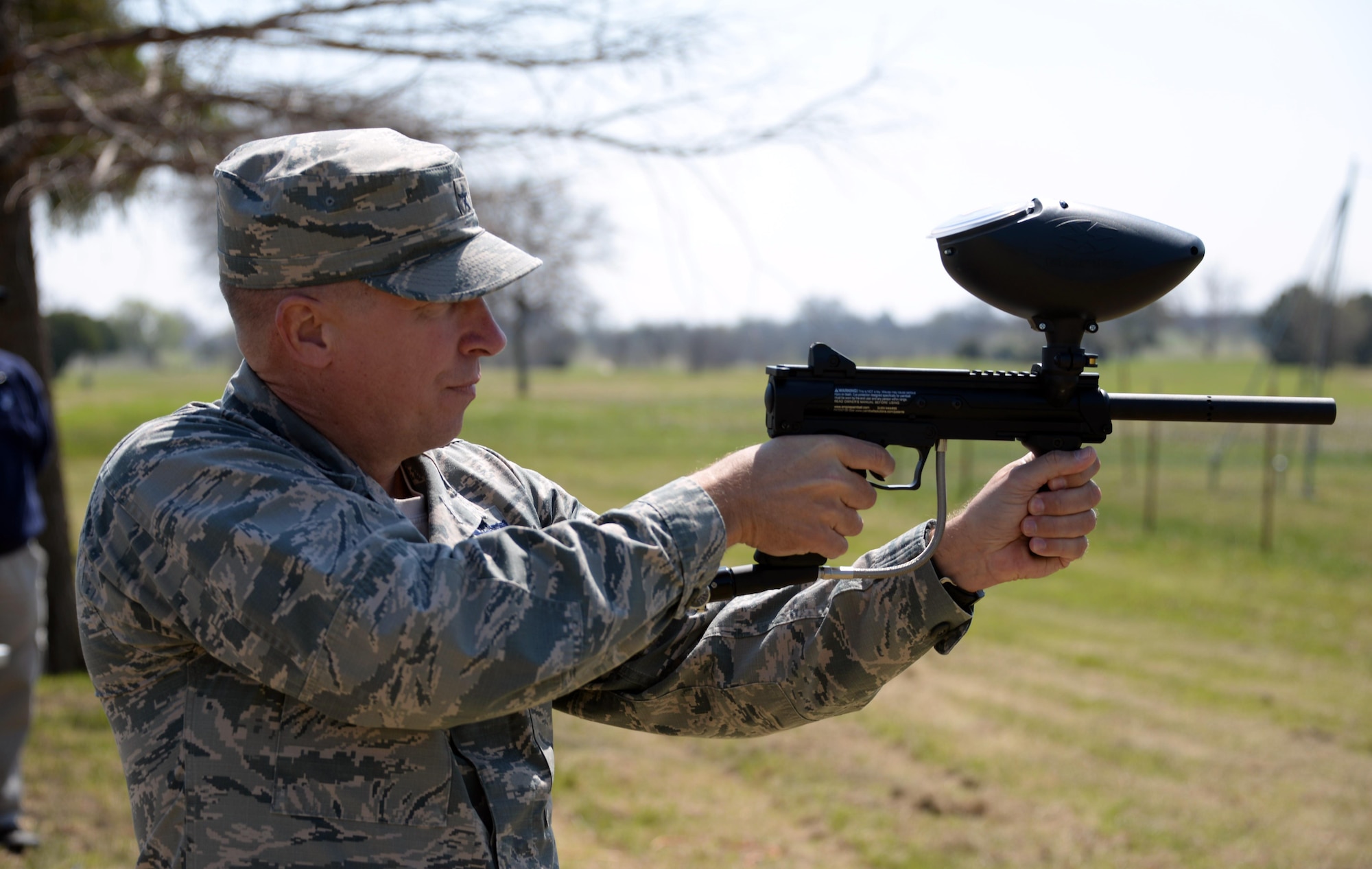 Brig. Gen. Patrick Doherty, 82nd Training Wing commander, test fires a paintball marker shortly after cutting the ribbon for the grand opening of the paintball facility at Sheppard Air Force Base, Texas, March 15, 2017. Along with the paintball facility, Wind Creek Park also offers a dog park, disc golf course and a jogging path. (U.S. Air Force photo by Senior Airman Robert L. McIlrath/Released)